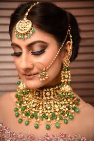 a bride wearing indian jewellery and looking down 