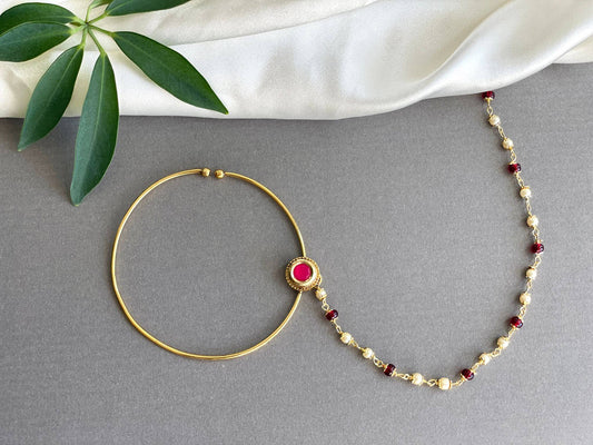 Red and Gold Nose Ring on a white background