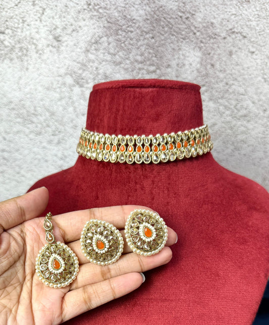 orange choker with matching earrings and tikka 