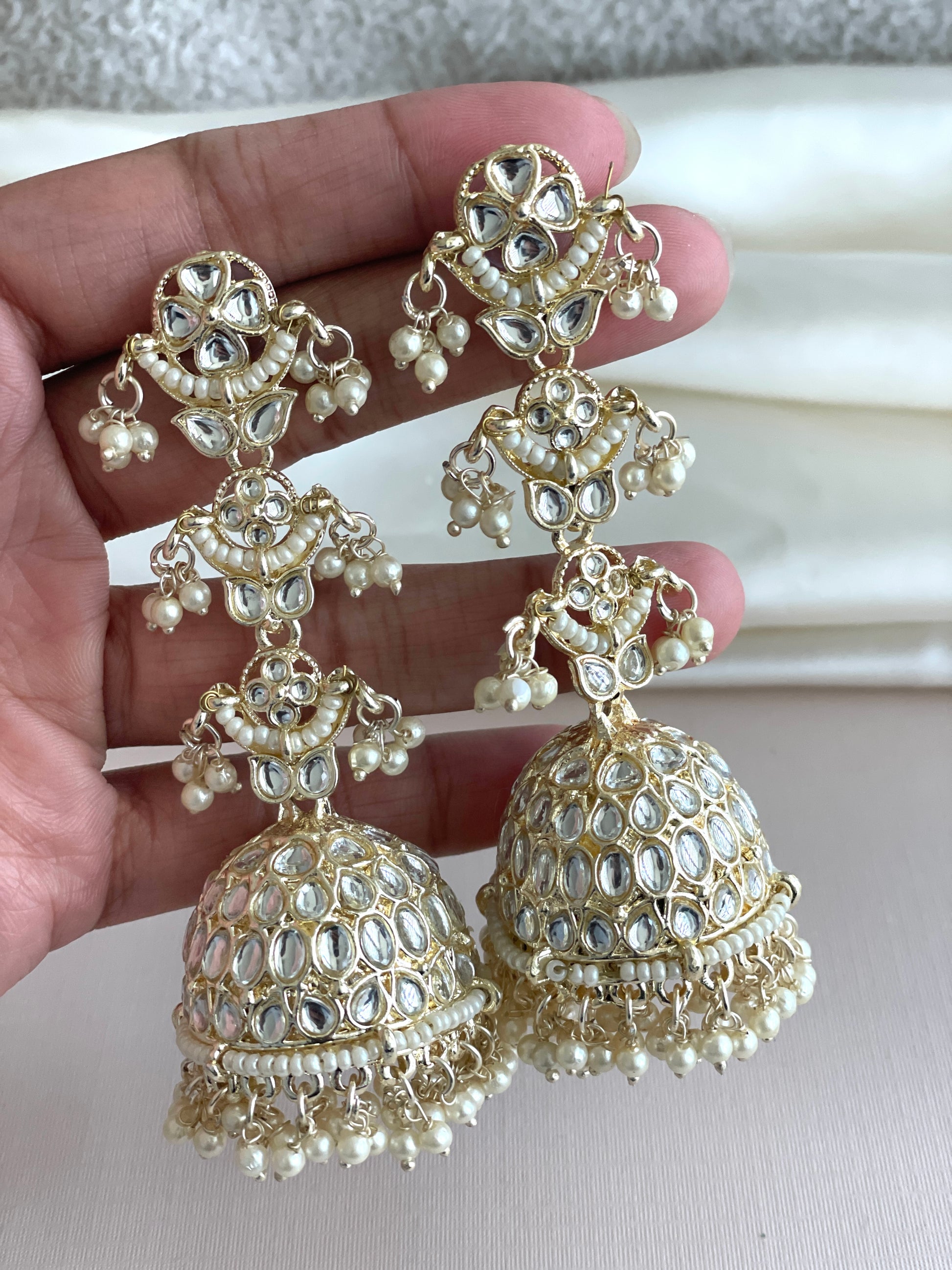 Beautiful long hanging jhumkas with intricate golden designs