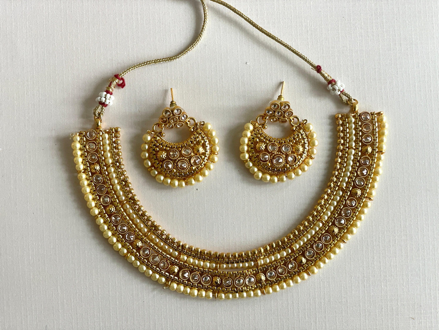 Gold necklace with pair of earrings